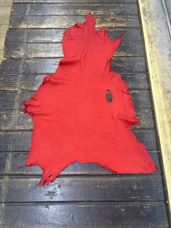 Red leather hide on wooden surface.