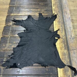 IMG_2336 Black leather hide on wooden surface.