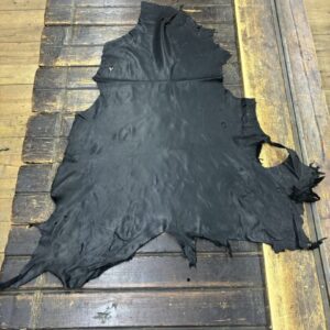 IMG_2340 Black leather hide on wooden surface.