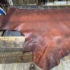 Leather hide on a wooden workbench.