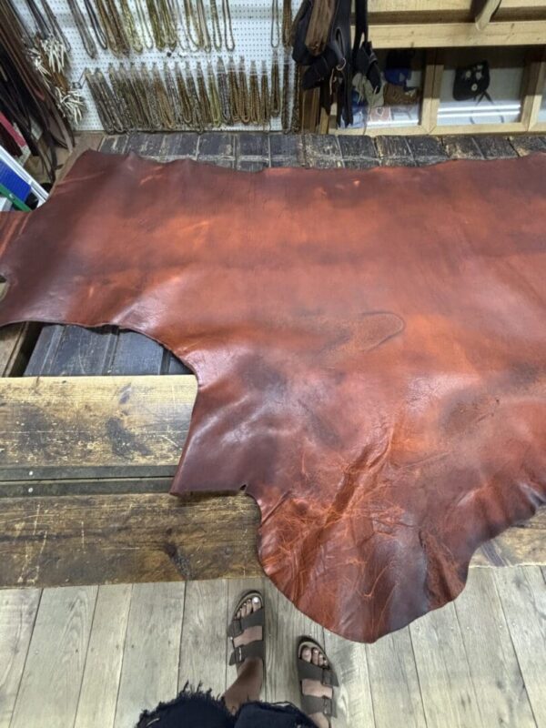Leather hide on a wooden workbench.