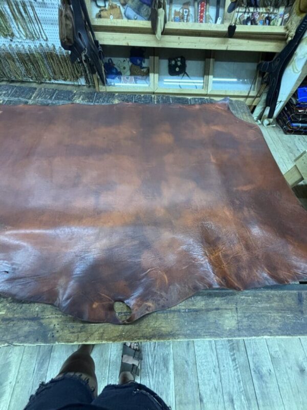 Brown leather hide on wooden table.