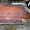 Red leather hide on a wooden table.