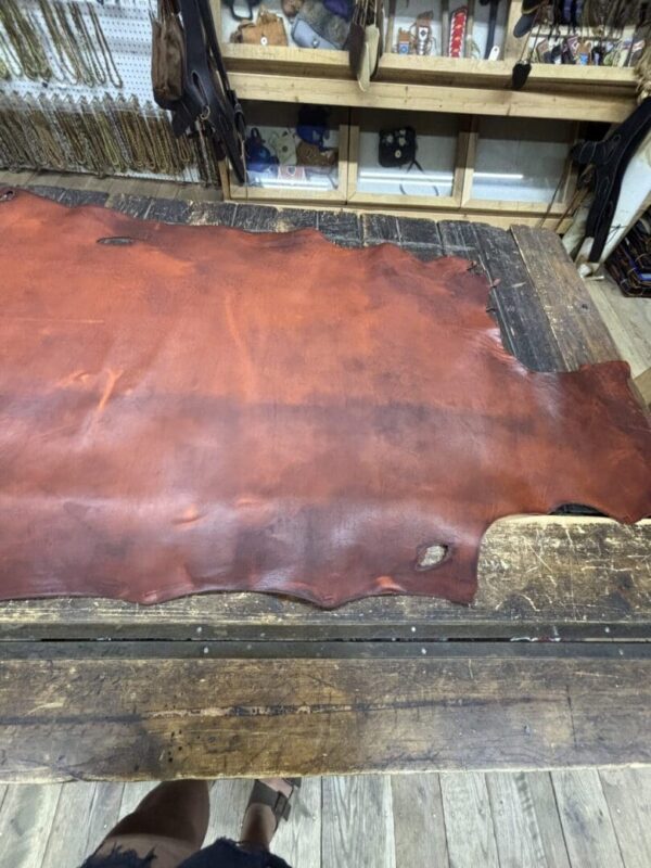 Red leather hide on a wooden table.