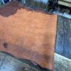 Leather hide on wooden workbench surface.