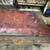 Tanned leather sheet on a wooden table.