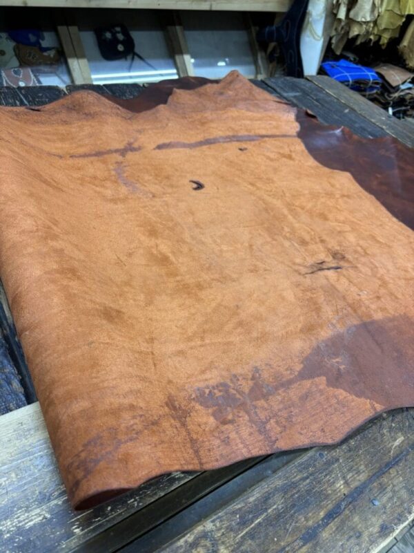 Brown leather sheet on wooden surface.
