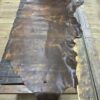 Brown leather hide on a wooden table.