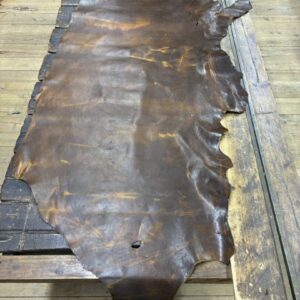 IMG_2445 Brown leather hide on a wooden table.