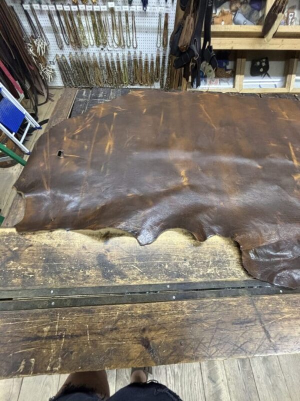 Brown leather hide on a workbench.