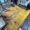 Yellow and brown leather hide on wooden table.