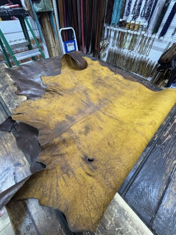 Yellow and brown leather hide on wooden table.