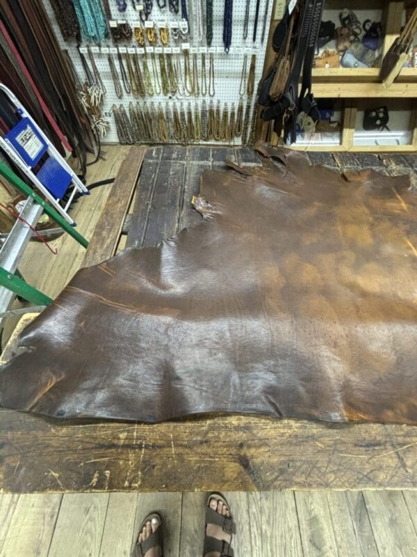 Leather hide on a workbench in workshop.