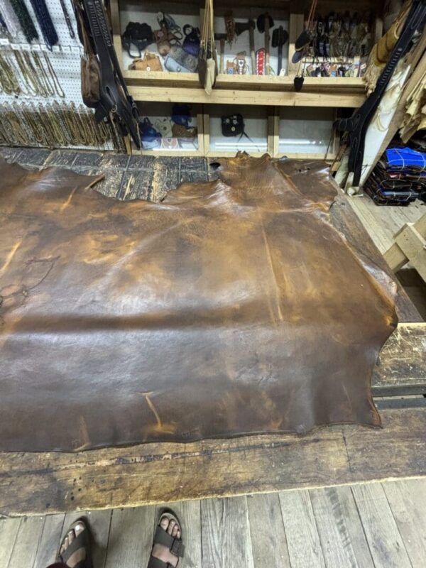 Leather piece on a wooden workspace.