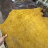 Yellow and brown leather pieces on a table.