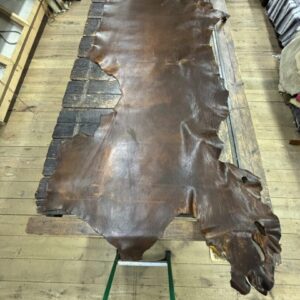 IMG_2458 Leather hide laid out on wooden table.