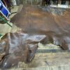 Brown leather hide on wooden table.