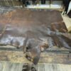 Brown leather hide on a wooden table.