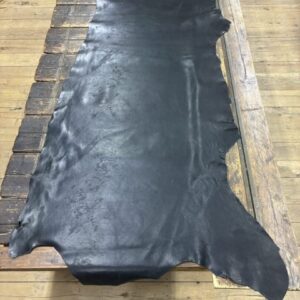 IMG_2471 Black leather hide on wooden table.