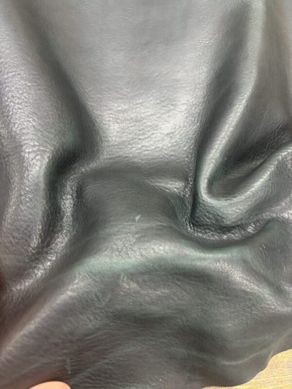 Close-up of dark green leather texture.