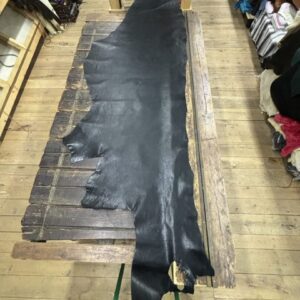 IMG_2478 Black leather hide on wooden table.