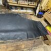Large black leather hide on table.