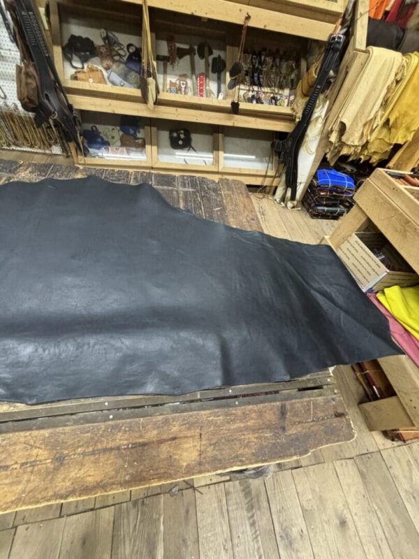 Large black leather hide on table.