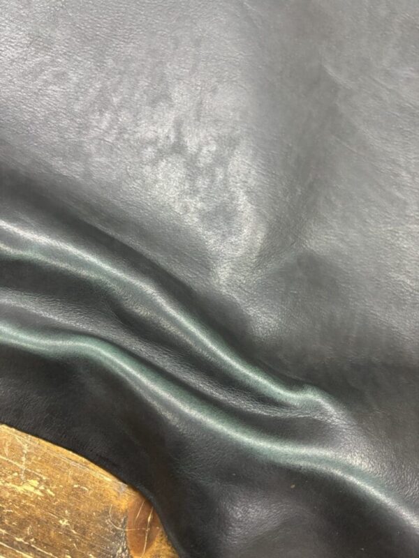 Black leather with wrinkles and texture.