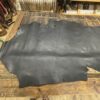 Black leather hide on wooden floor.