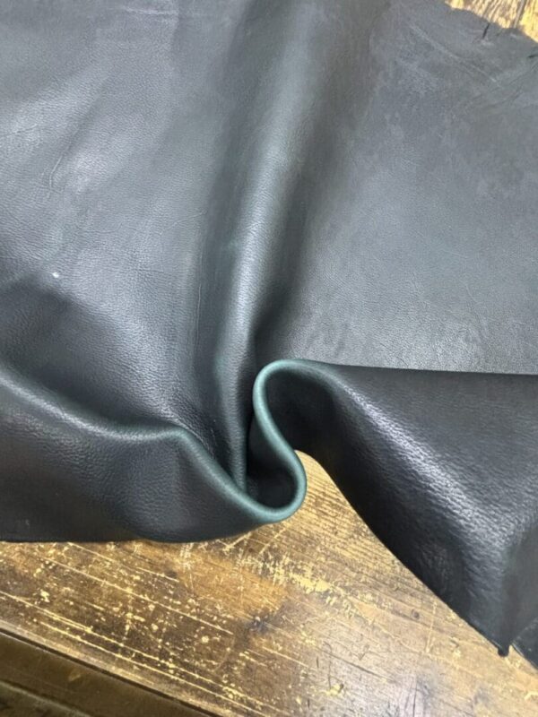 Black leather with green edge.