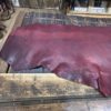 Red leather hide on wooden surface.