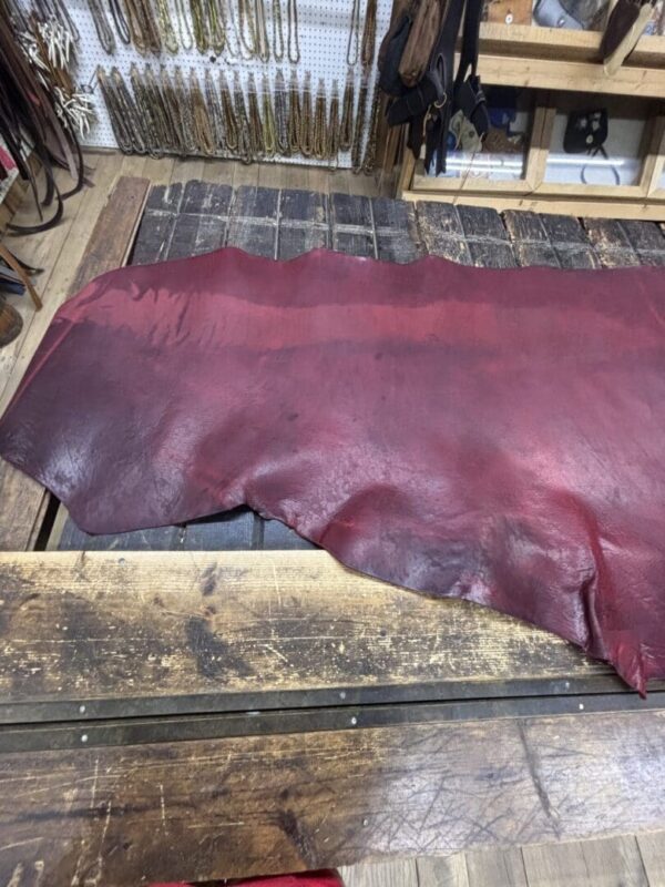Red leather hide on wooden surface.