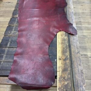 IMG_2566 Burgundy leather hide on wooden surface.