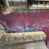 Red leather on wooden workbench.