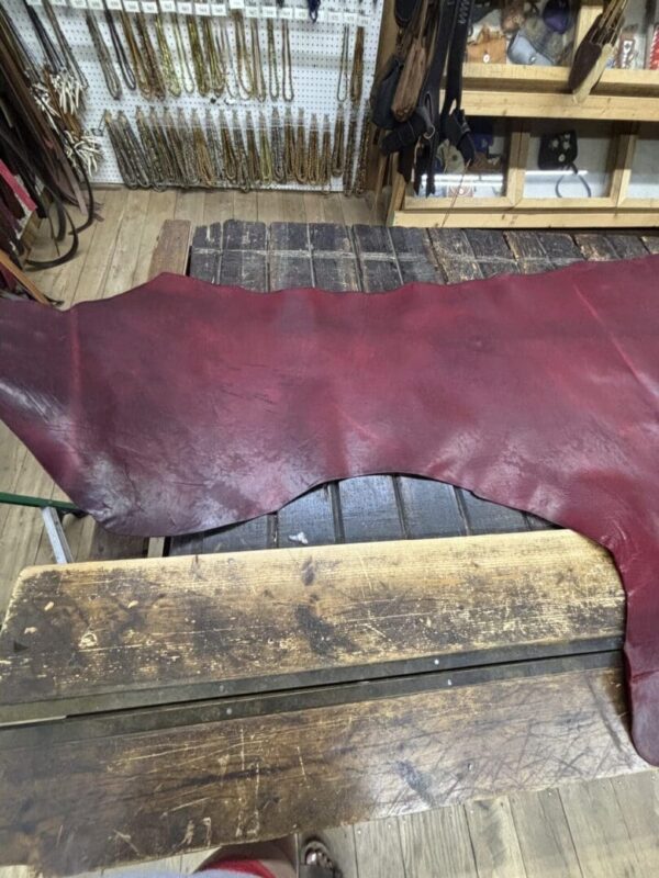 Red leather on wooden workbench.