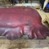 Red leather hide on wooden table.