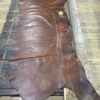 Brown leather hide on wooden table.