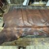 Large brown leather hide on wood.