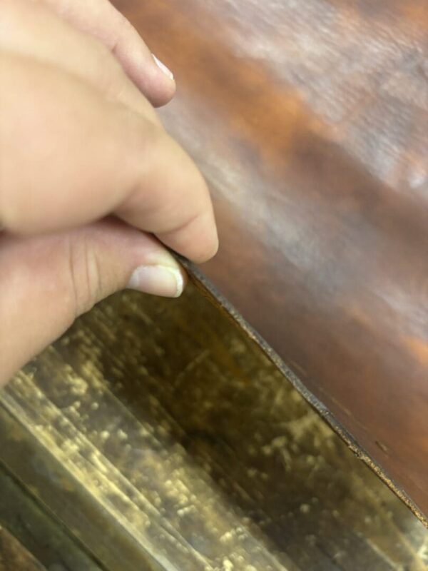 Hand lifting brown leather cover