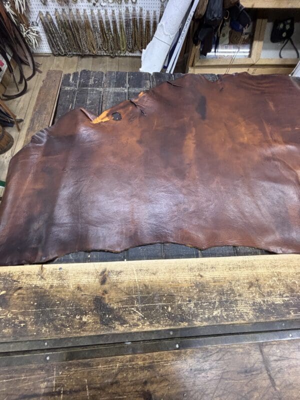 Brown leather sheet on a wooden table.