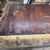 IMG_2662 Brown leather sheet on a wooden table.