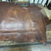 IMG_2663 Brown leather hide on wooden table.