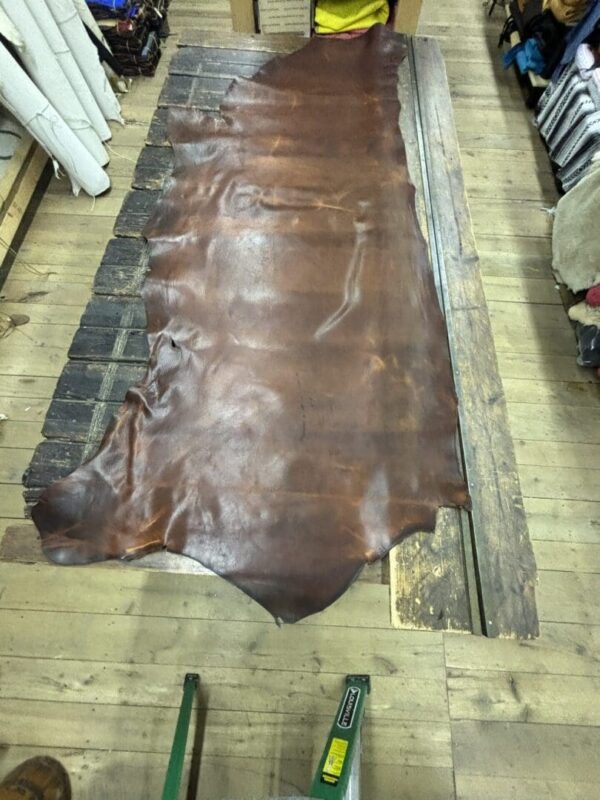 IMG_2669 Large brown leather hide on wood floor.