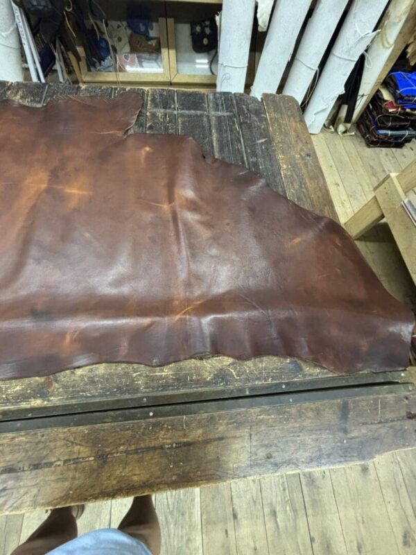IMG_2671 Brown leather sheet on wooden table.