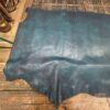 Teal leather hide on wood table.