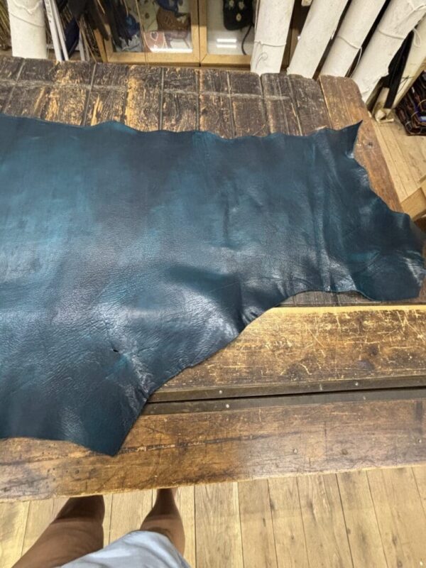 Teal leather on a wooden table.
