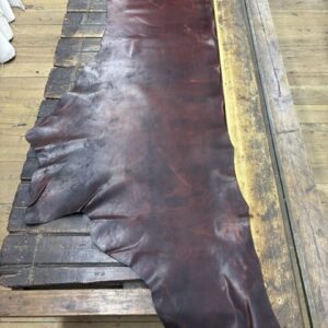 IMG_2717 Dark brown leather hide on wooden table.
