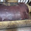Dark brown leather hide on wood.