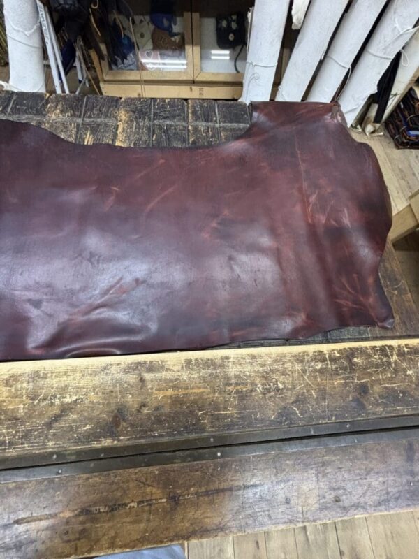 Dark brown leather hide on wood.