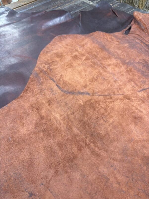 Brown leather hide on wooden surface.